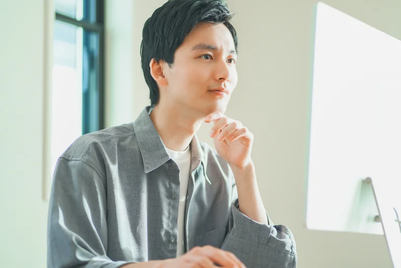 口元に手を当てて考える社員
